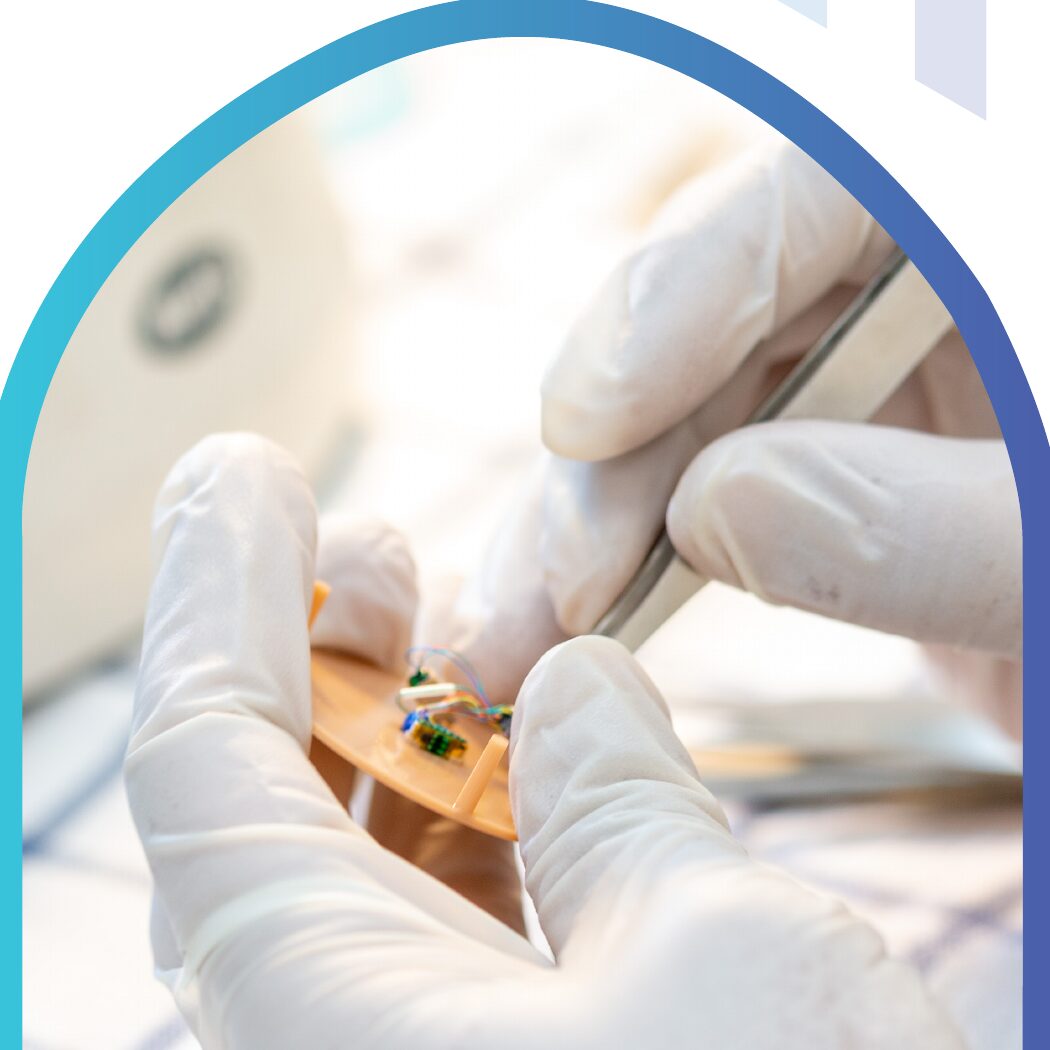 Close-up of a hearing-aid component being assembled