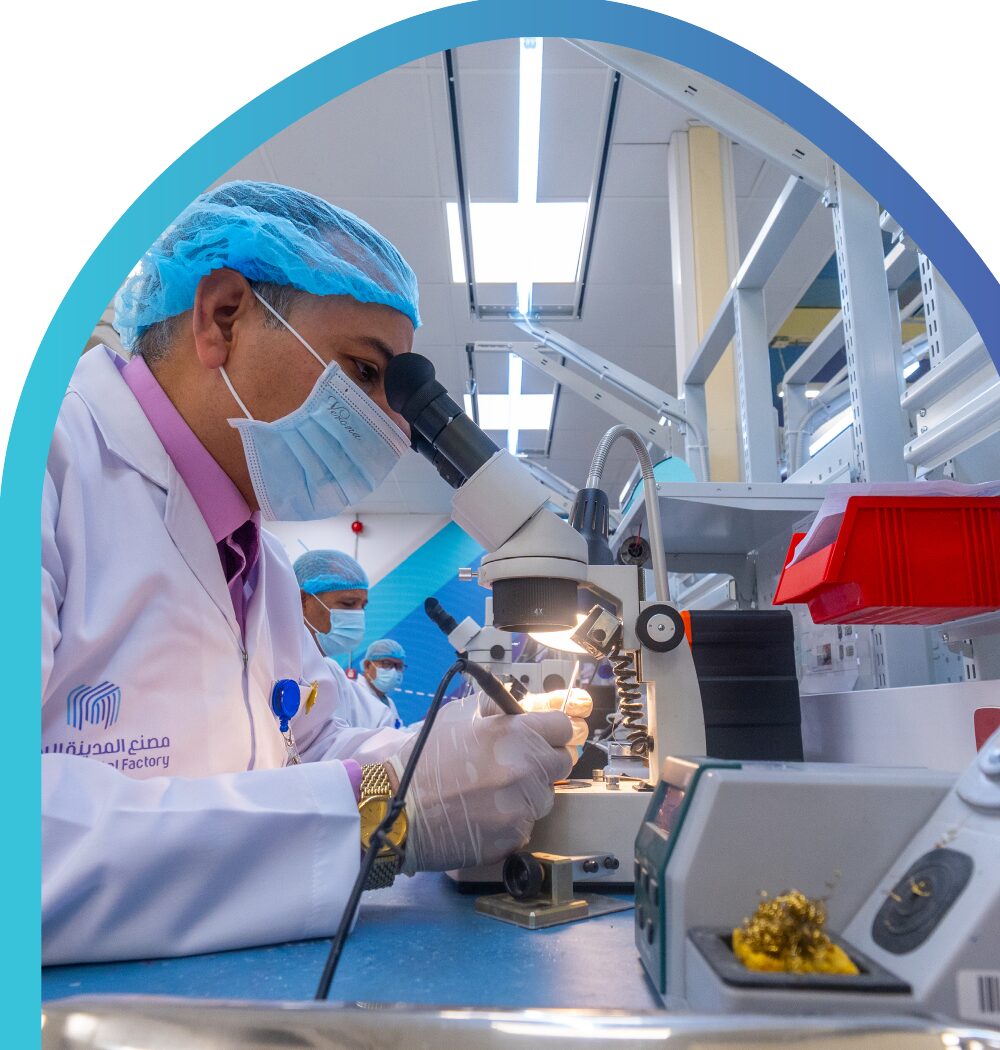 Technician inspecting a component under a microscope